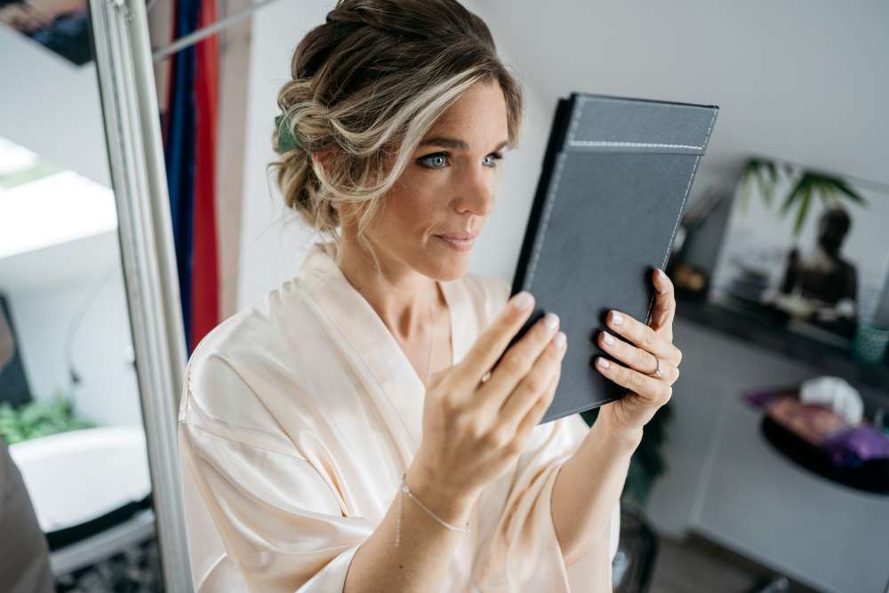 bride looks at herself in the mirror