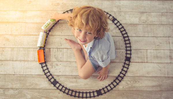 child with lgb train playing