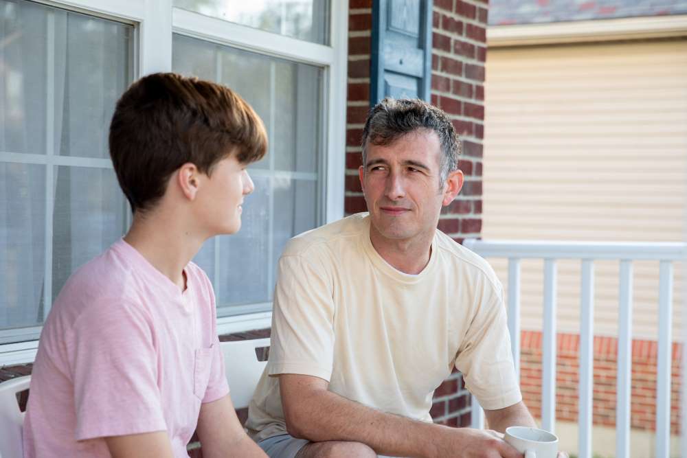 Father sitting next to his son talking about substance use