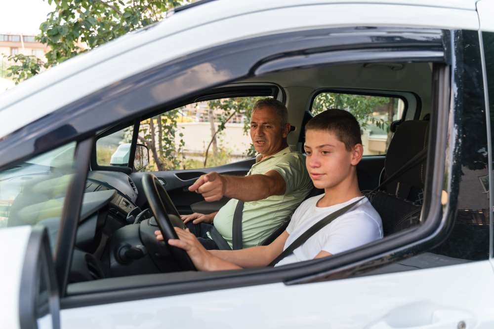 father teaching son to drive