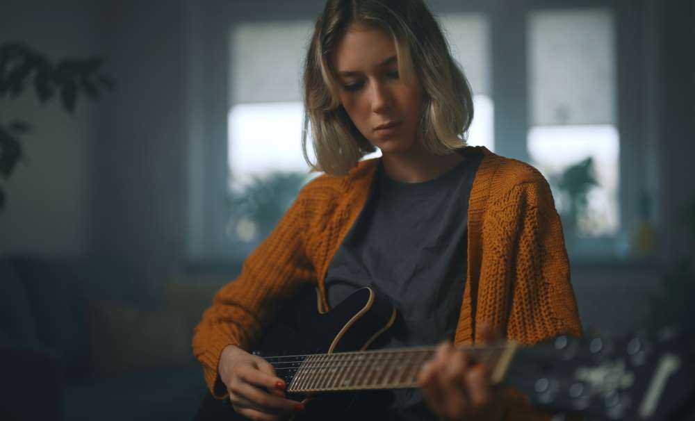 girl playing electric guitar
