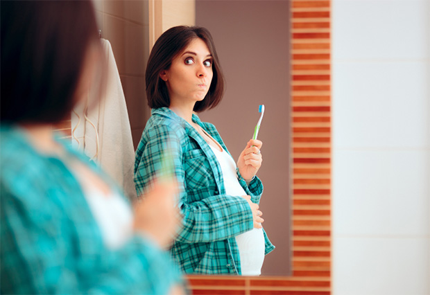 A pregnant woman notices blood when brushing and flossing her teeth.