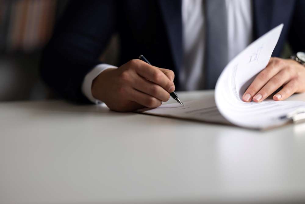 injury attorney signing paperwork