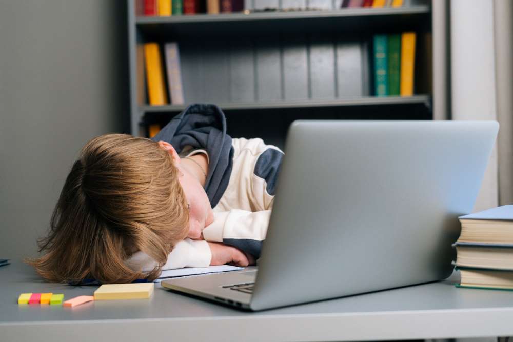 kid sleeping on laptop