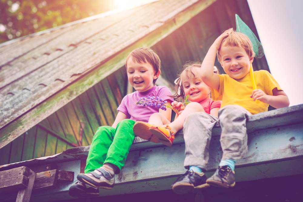 kids sitting on a roof top
