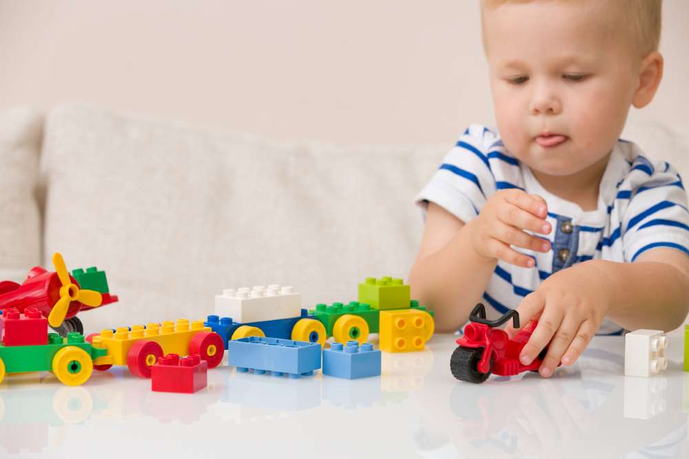 child playing with lego
