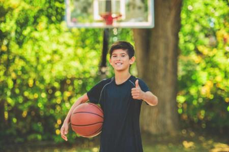 kid playing basketball outside