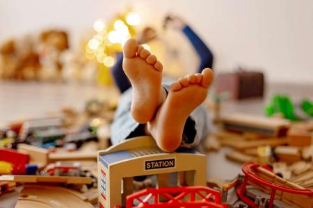 kid playing on a leather sofa