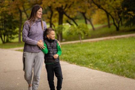 mother and son walk in a park