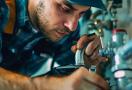 a professional plumber fixing a leaky faucet with tools nearby.