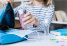 kid packing hand sanitizer at school