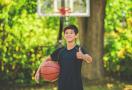 kid playing basketball outside