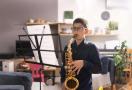 kid playing sax