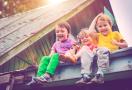 kids sitting on a roof top