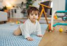 Toddler crawling and playing with toys