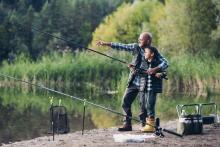 dad teaching son to fish