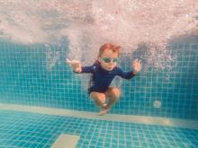 kid diving in a pool