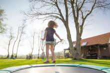 a kid jumping on trampoline