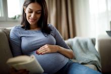 pregnant woman reading parenting book