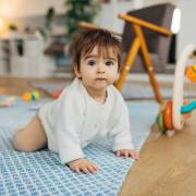 Toddler crawling and playing with toys
